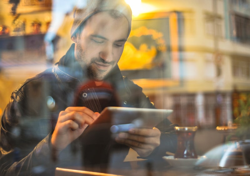 image of man on ipad using WordPress Web Hosting Plans in Northern Ireland